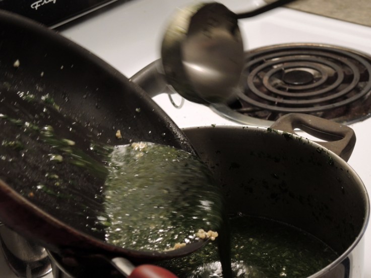 Home Is A Kitchen - Pouring Molokhia over Sateed Garlic